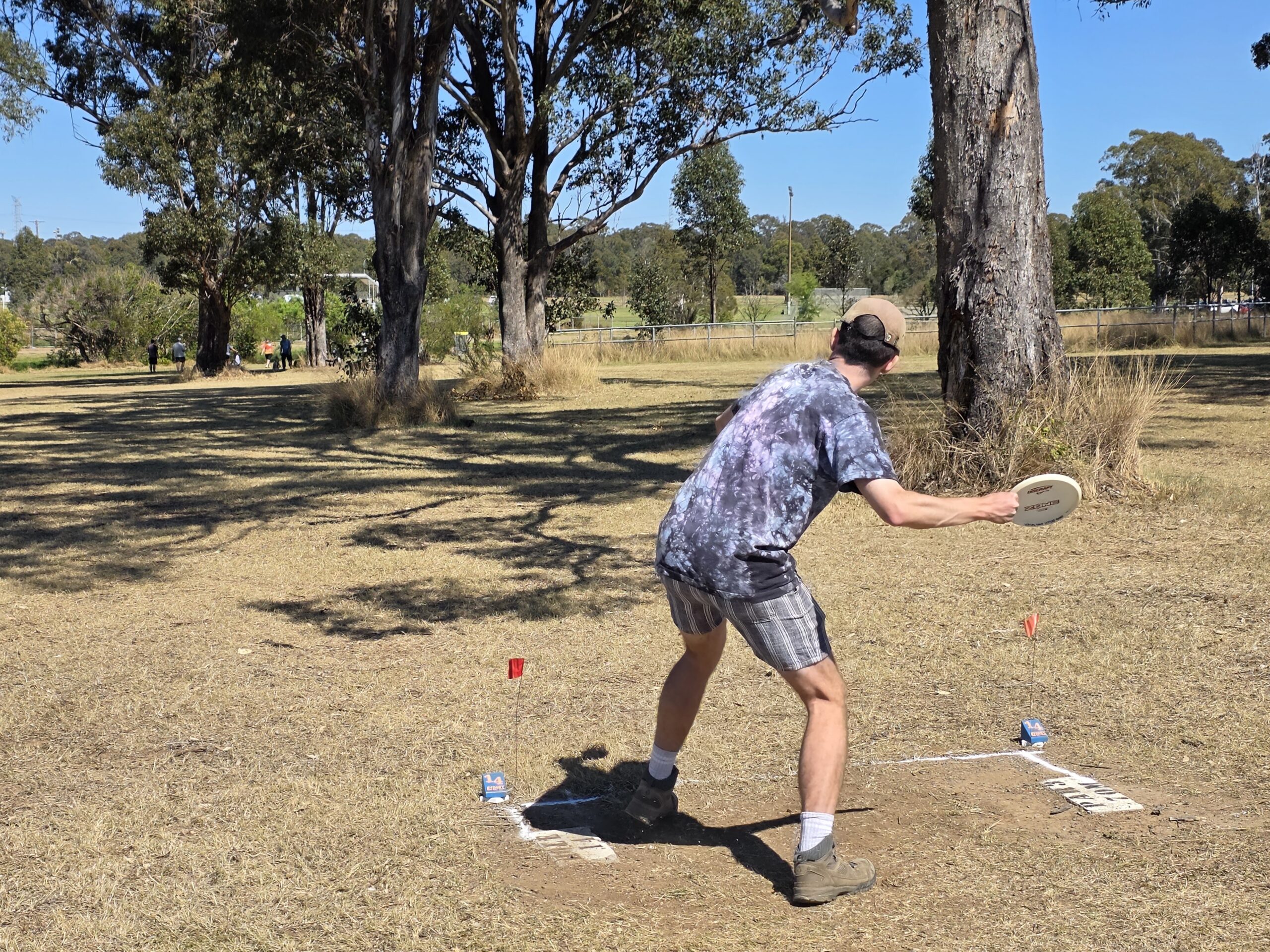 A disc golfer tees up a shot at Australian Disc Golf Day 2026 in Whalan Reserve NSW
